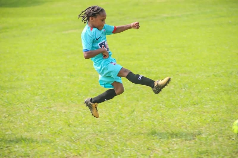 Young athlete striking the ball during MCAL soccer play