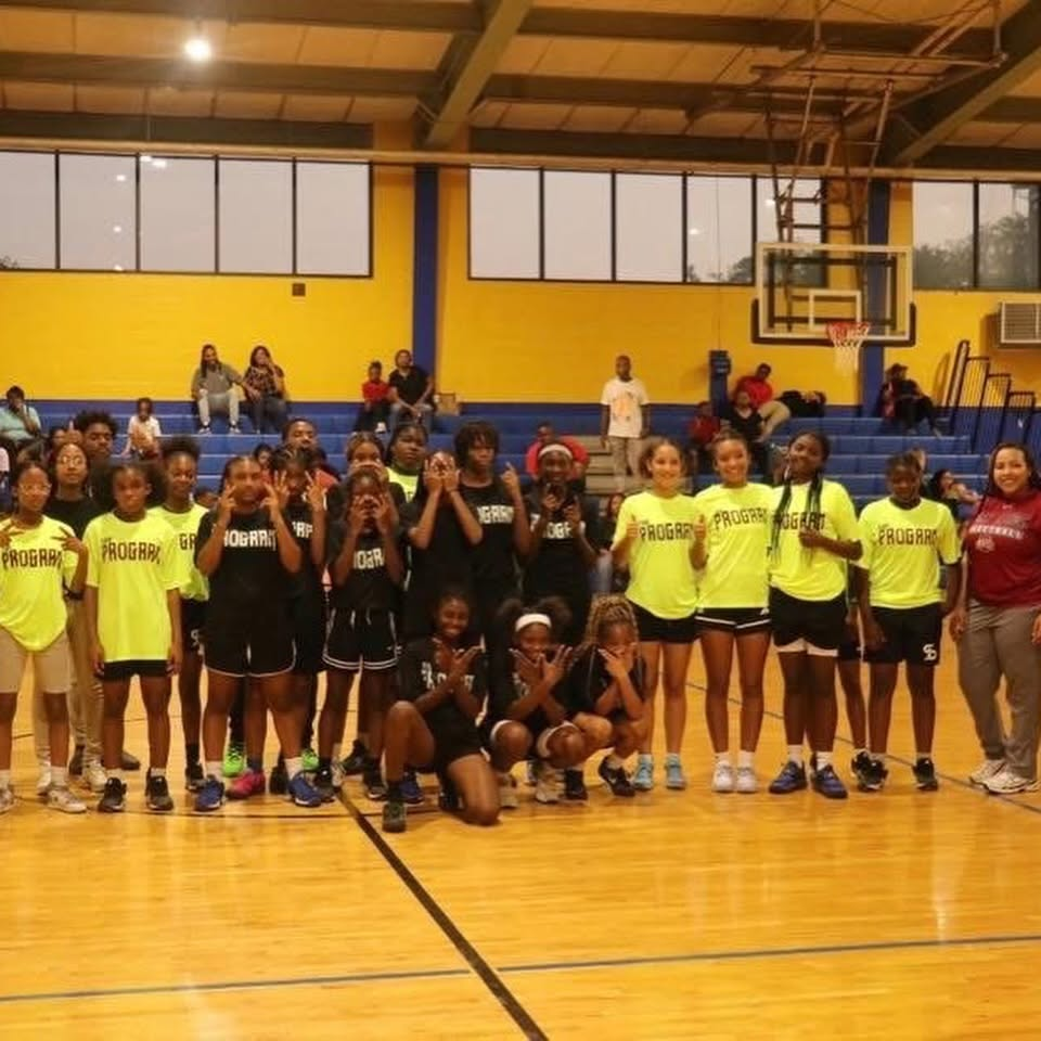MCAL girls basketball program teams lined up in the gym